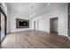 Living room featuring wood-style flooring and a wall-mounted TV at 10748 Steel Ridge Ct, Las Vegas, NV 89135