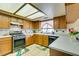 Spacious kitchen with wooden cabinets, stainless steel appliances, and decorative tile floor at 1464 Briggs Ct, Las Vegas, NV 89110