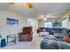 Living area featuring a large sectional sofa, recliner, and ceiling fan at 1464 Briggs Ct, Las Vegas, NV 89110