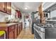 Compact kitchen featuring dark wood cabinets, a gas stove, and tile flooring at 1812 Brand St, North Las Vegas, NV 89030