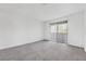 Spacious, carpeted bedroom with sliding glass doors leading to a balcony at 1814 N Decatur Blvd # 204, Las Vegas, NV 89108