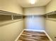 Large walk-in closet with double hanging rods and wood-look floors at 2053 Jasper Bluff St # 201, Las Vegas, NV 89117