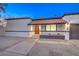 Front view of a single story home with red tile roof and a red door at 2500 W Oakey Blvd, Las Vegas, NV 89102