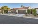 Front exterior of a two-story home with attached garages, landscaping, and a paved driveway at 3143 Sonata Dr, Las Vegas, NV 89121