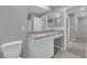 Bathroom vanity with a large mirror, white cabinets, and a neutral countertop at 3217 Pergusa Dr, Henderson, NV 89044