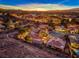 Night aerial view of community, showcasing homes and city lights at 46 Moraine Dr, Henderson, NV 89052