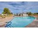 Inviting community pool with a shaded seating area and surrounding greenery at 4905 Birch Bay Ln, Las Vegas, NV 89130