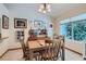 Dining area with large window, wooden table, and charming decor at 4905 Birch Bay Ln, Las Vegas, NV 89130