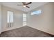 Empty bedroom with carpet, ceiling fan, windows, and curtains at 513 Founders Creek Ave, North Las Vegas, NV 89084