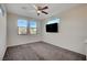 Spacious, carpeted loft with large windows, a ceiling fan, and wall-mounted TV at 513 Founders Creek Ave, North Las Vegas, NV 89084