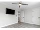 Bright bedroom with gray walls, wood-look flooring, and a ceiling fan at 5456 Digne Ct, Las Vegas, NV 89141