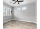 Empty bedroom with gray walls, wood-style flooring, and shuttered window at 5456 Digne Ct, Las Vegas, NV 89141