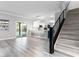 Living room with gray wood-look floors, a staircase, and views of the kitchen at 5456 Digne Ct, Las Vegas, NV 89141