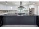 Close-up of the sleek kitchen island with black marble countertop and cooktop at 5600 Topaz St, Las Vegas, NV 89120