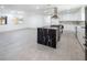 Open concept kitchen and dining area with a large black island at 5600 Topaz St, Las Vegas, NV 89120