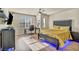 Modern bedroom with a yellow comforter and blue LED lights at 5728 Collier Falls Ave, Las Vegas, NV 89139