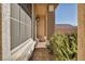 A welcoming front entry with a paved walkway, screened windows, and a charming outdoor light fixture at 5728 Collier Falls Ave, Las Vegas, NV 89139