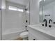 Clean, modern bathroom with white vanity, black fixtures, and a shower/tub combo at 5934 Clear Valley Ave, Las Vegas, NV 89142