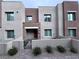 Modern townhome exterior with stone accents and a gated entryway at 600 N Carriage Hill Dr # 1113, Las Vegas, NV 89138