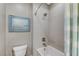 Modern bathroom with shower/tub combo, tiled walls, and decorative curtain at 6800 Equinox Cliff St, Las Vegas, NV 89135