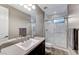 Modern bathroom with a walk-in shower and dark vanity at 6800 Equinox Cliff St, Las Vegas, NV 89135