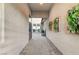 Private courtyard with pavers, gravel, succulent wall art, and a glimpse of a water feature at 6800 Equinox Cliff St, Las Vegas, NV 89135