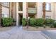 Walkway to condo lined with green bushes and palm trees at 7163 S Durango Dr # 113, Las Vegas, NV 89113