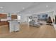 Open concept living area with wood-look flooring, a sectional sofa, and a decorated Christmas tree at 7986 Adelaide Hills St, Las Vegas, NV 89113