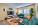 Second living room or loft area with teal sectional sofa and colorful accents at 8029 Ancient Oaks Ave, Las Vegas, NV 89113