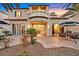 Backyard patio of a two-story home with palm trees, patio furniture, and a balcony at 8390 Carmel Ridge Ct, Las Vegas, NV 89113