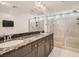 Luxurious ensuite bathroom with double sinks, and a glass shower at 10308 Rolling Bay Ct, Las Vegas, NV 89141