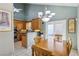 Dining area with a wooden table and chairs, adjacent to the kitchen at 1179 King Arthur Ct, Henderson, NV 89002