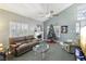 Cozy living room with a decorated Christmas tree, a fireplace, and plush seating at 1179 King Arthur Ct, Henderson, NV 89002