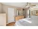 Main bedroom featuring a ceiling fan, closet, dresser, and attached bathroom with vanity and soaking tub at 1179 King Arthur Ct, Henderson, NV 89002