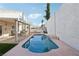 Private pool with a covered patio area and white wall at 1179 King Arthur Ct, Henderson, NV 89002