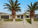 Inviting single-story home with palm trees, a gated front yard, and a paved walkway at 1240 Linn Ln, Las Vegas, NV 89110