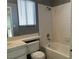 Bathroom with gray tiled shower, white vanity, and toilet at 127 Coventry Cir, Henderson, NV 89074