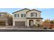 Two-story home with a brown and tan facade, attached garage, and landscaped front yard at 157 Ned Lagrotta Ave, Las Vegas, NV 89183