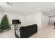 Cozy living room featuring a dark couch, christmas tree and neutral walls at 157 Ned Lagrotta Ave, Las Vegas, NV 89183