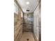 Luxurious walk-in shower with a rainfall showerhead and textured tile walls at 157 Ned Lagrotta Ave, Las Vegas, NV 89183