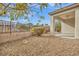 Backyard with a covered patio, gravel landscaping, and a view of neighboring homes at 2591 Binary Stars St, Henderson, NV 89044