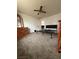 Carpeted bedroom with a metal bed frame, wooden dresser, and ceiling fan at 26 Avenue E, McGill, NV 89318