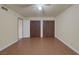 Spacious bedroom with wood-look tile floors and double closets at 401 Altamira Rd, Las Vegas, NV 89145