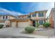 Tan two-story house with green shutters and a three-car garage at 4017 Gaster Ave, North Las Vegas, NV 89081