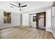 Spacious bedroom with mirrored closet doors, ceiling fan, and wood-look floors at 4541 Largo Cantata St, Las Vegas, NV 89135