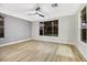 Bedroom with wood-look flooring, ceiling fan, and large windows at 4541 Largo Cantata St, Las Vegas, NV 89135