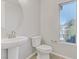 Simple bathroom with pedestal sink, toilet and a window at 542 Celebratory Pl, Henderson, NV 89011