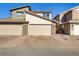 Three-car garage with stone accents and paver driveway at 542 Celebratory Pl, Henderson, NV 89011