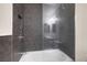 Clean bathroom with modern gray tile, shower/tub combo, and updated fixtures at 5975 Via Capri, Las Vegas, NV 89122