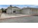 Front exterior of a single-story home with attached garage and gated driveway at 5975 Via Capri, Las Vegas, NV 89122